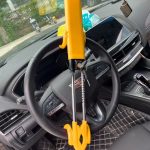 QC001 adjustable double-hook steering wheel lock installed in a car