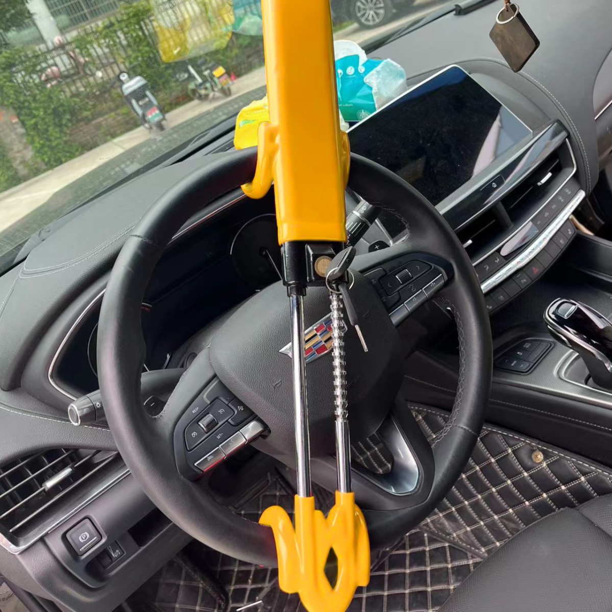 QC001 adjustable double-hook steering wheel lock installed in a car